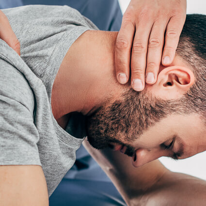 Chiropractor performing a neck adjustment on a patient